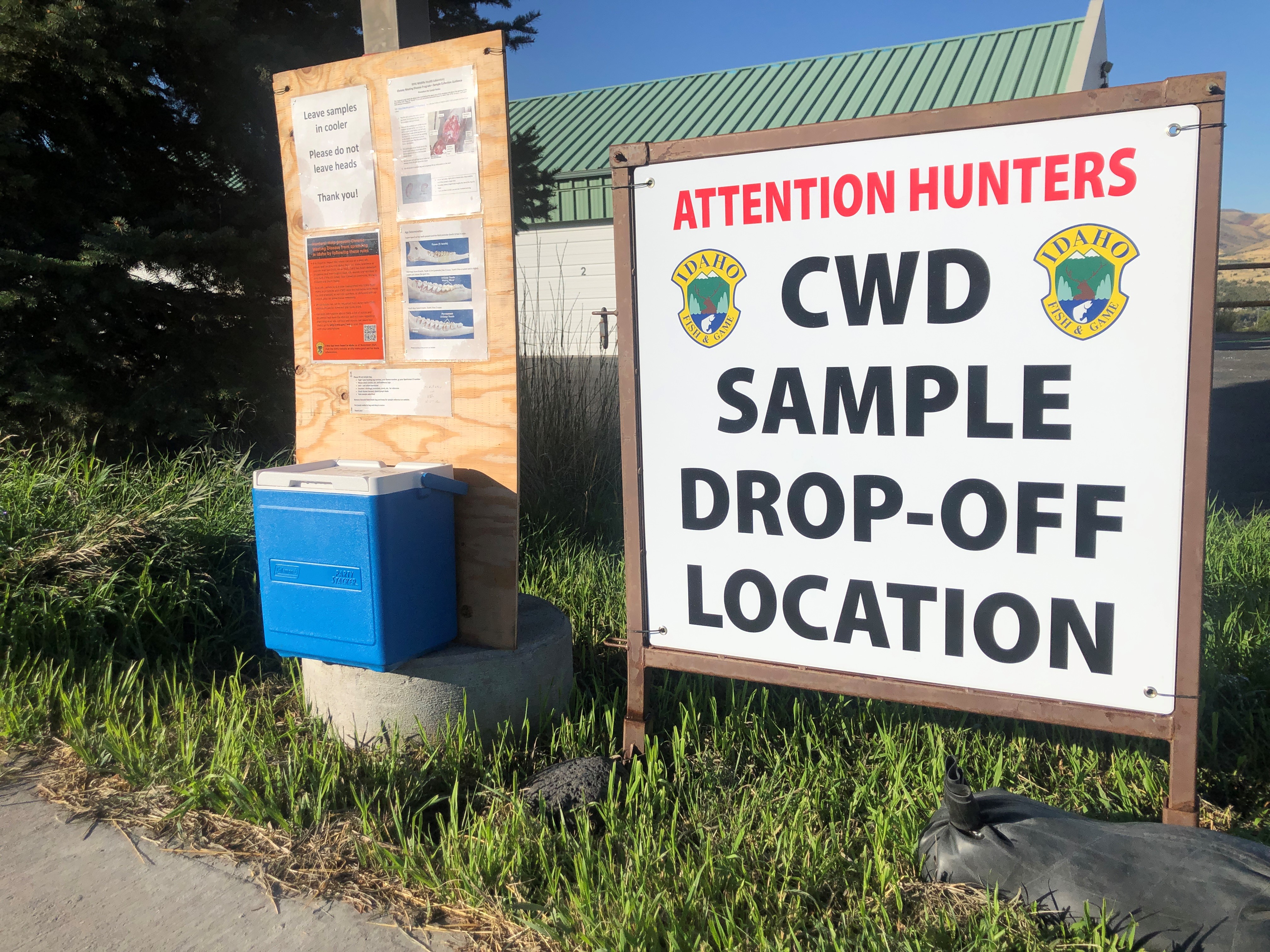 A CWD sample drop-off can and sign.