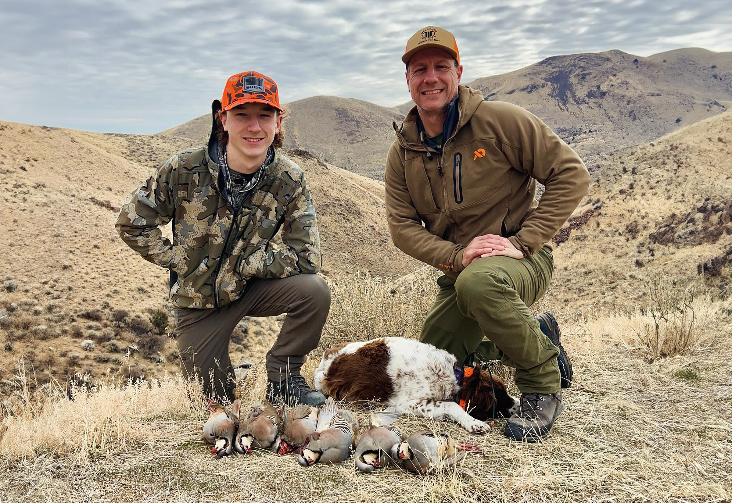 upland bird hunter and son with chukars and bird dog