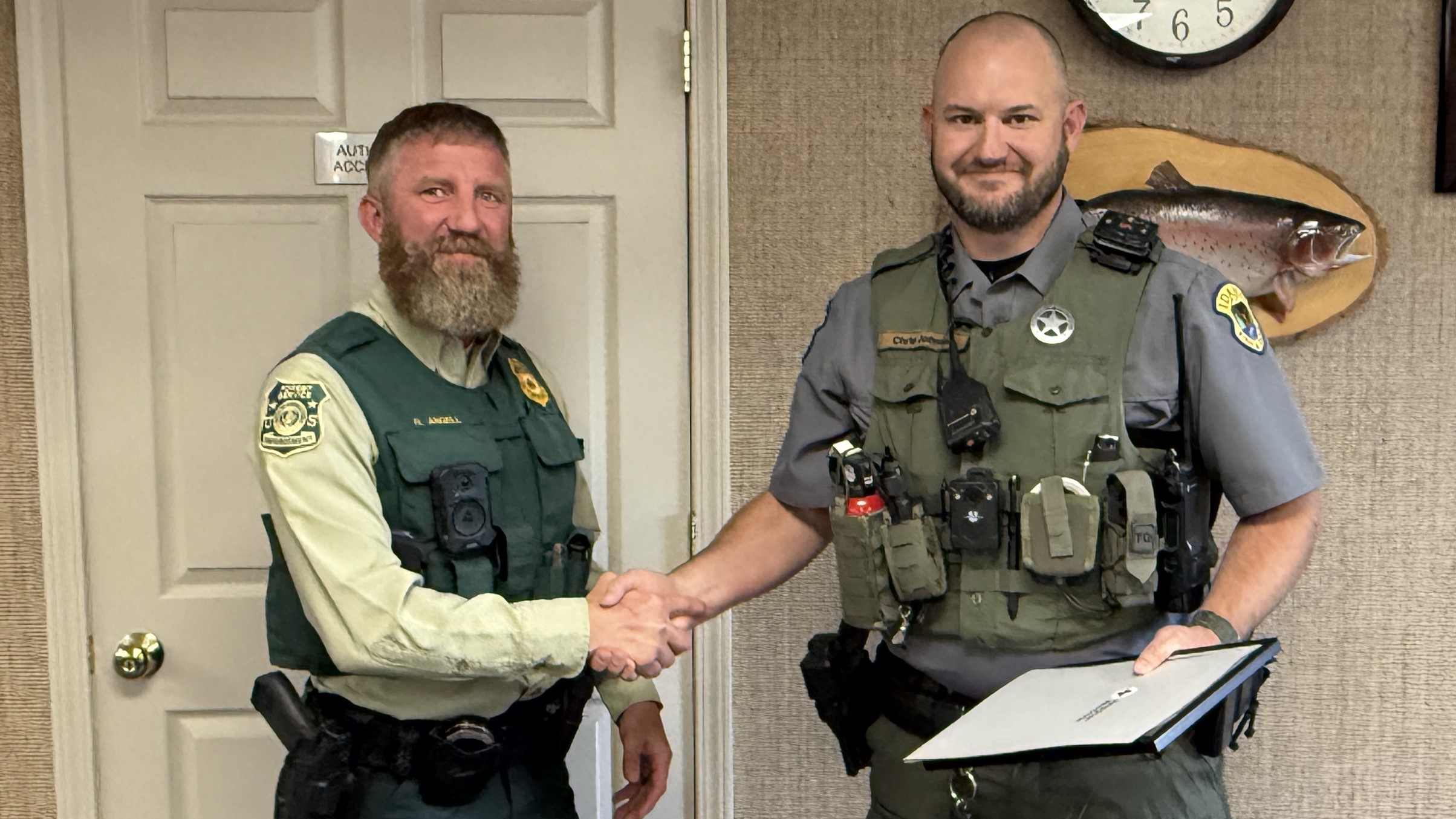Officer Angel handing Red Cross Life Saving Award to Officer Chris Johnson
