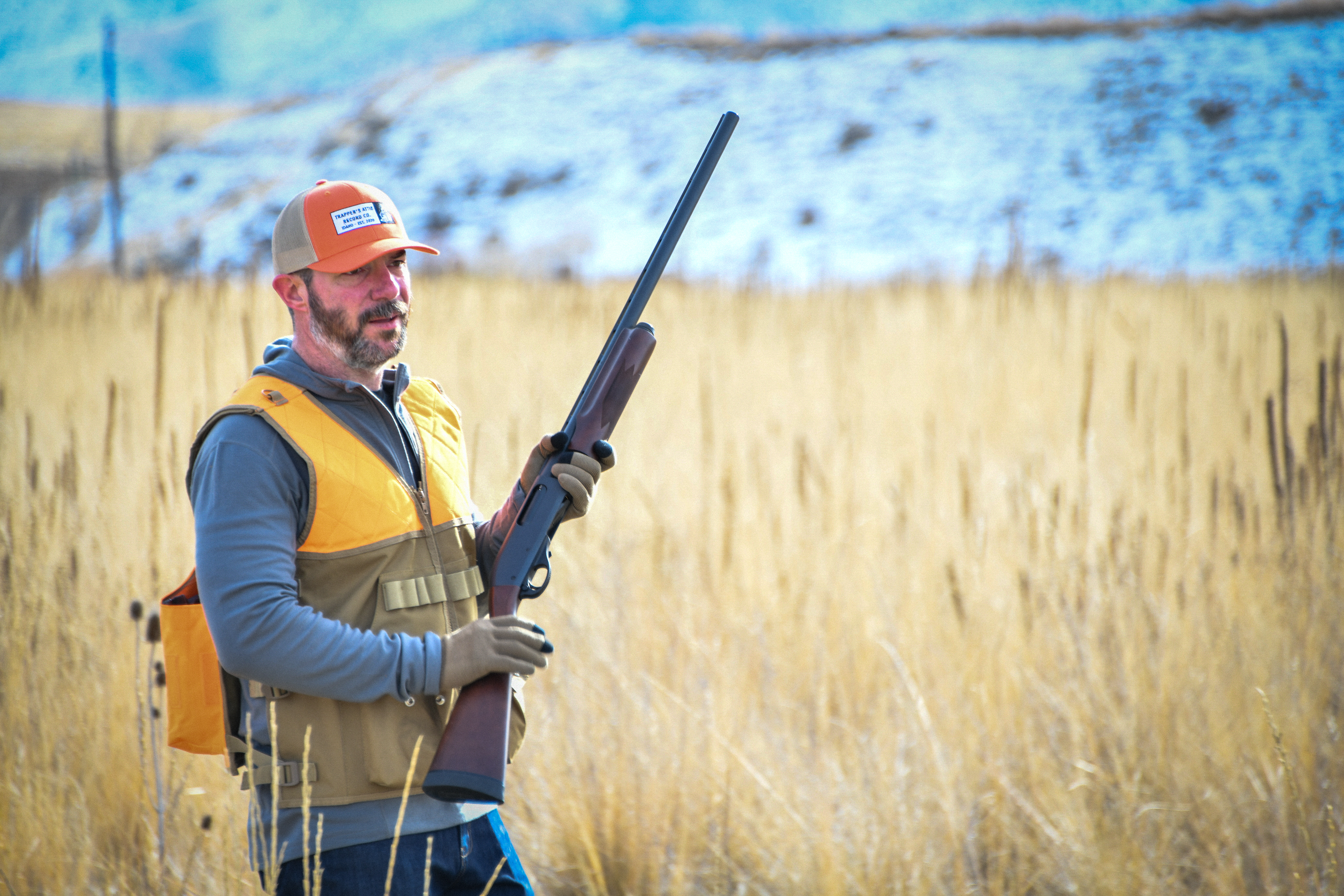 upland bird hunter with shotgun muzzle pointed in the air