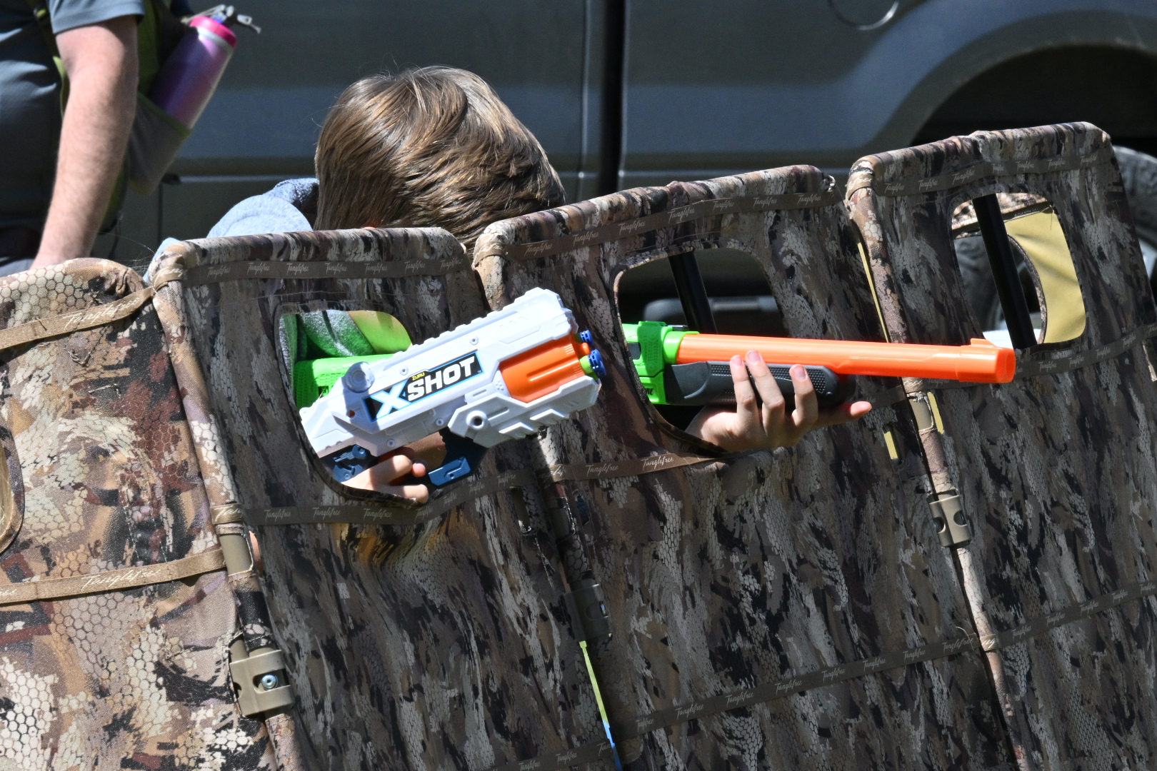 Nerf guns being pointed out of a duck blind 