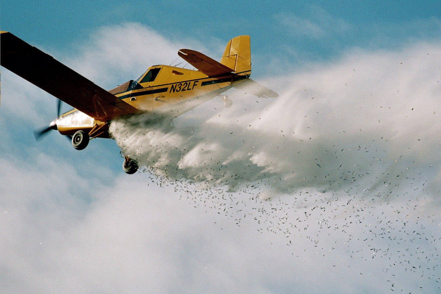 A fixed-wing plane stocks fish into a lake in Alaska.