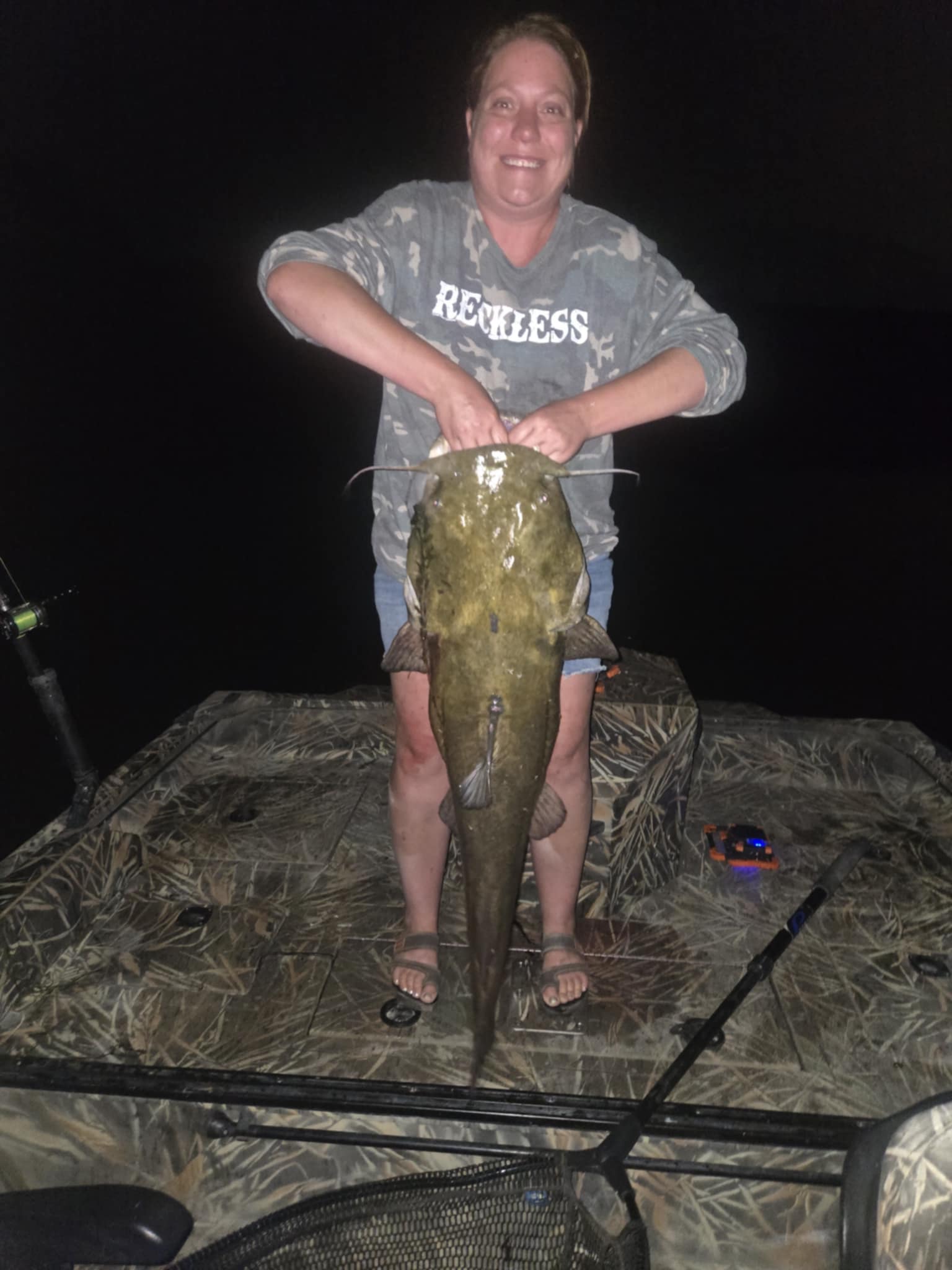 Brandi Holt holding 44-inch flathead catfish from Snake River (vertical)