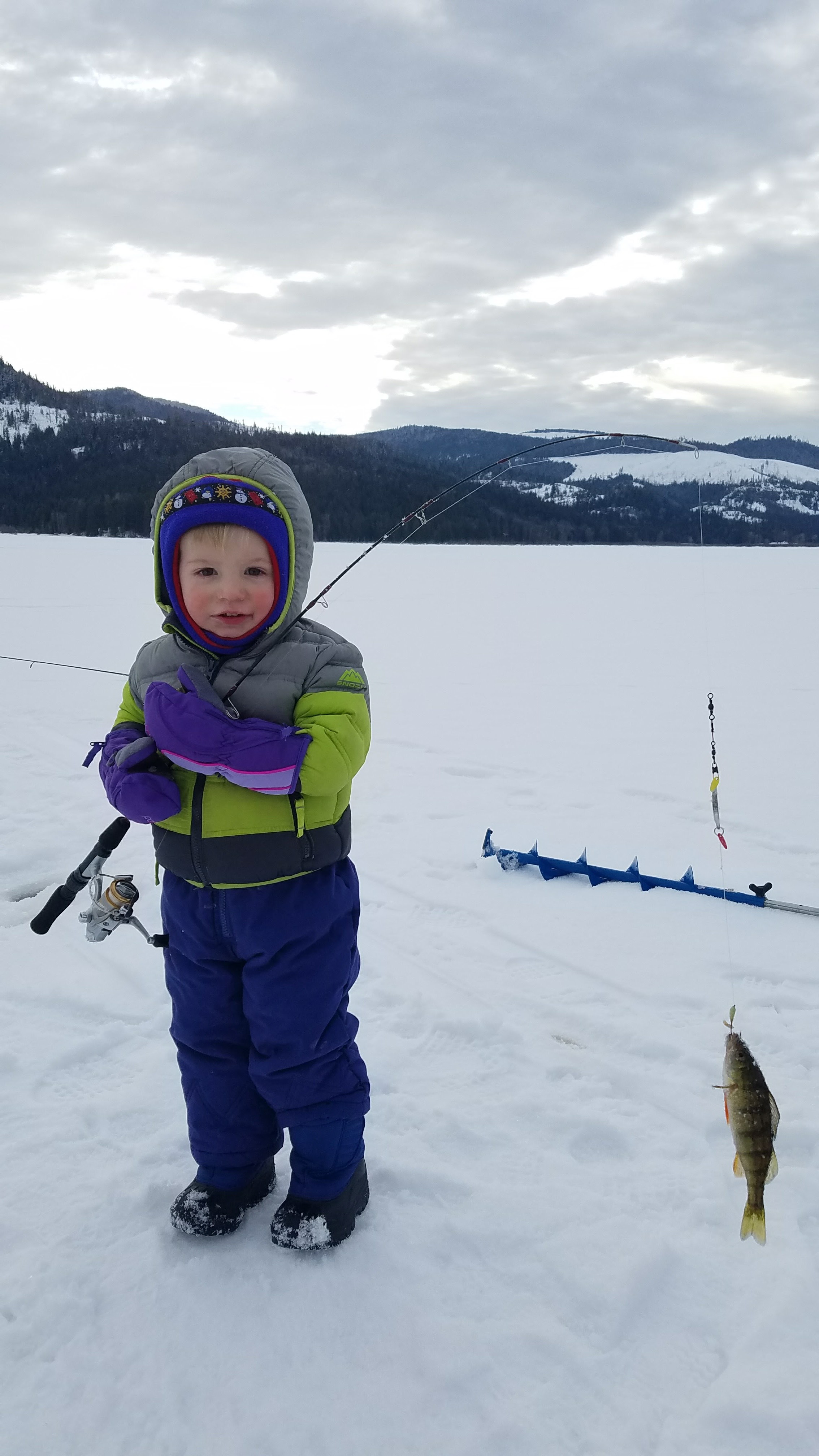 A boy and his firsh fish on the ice