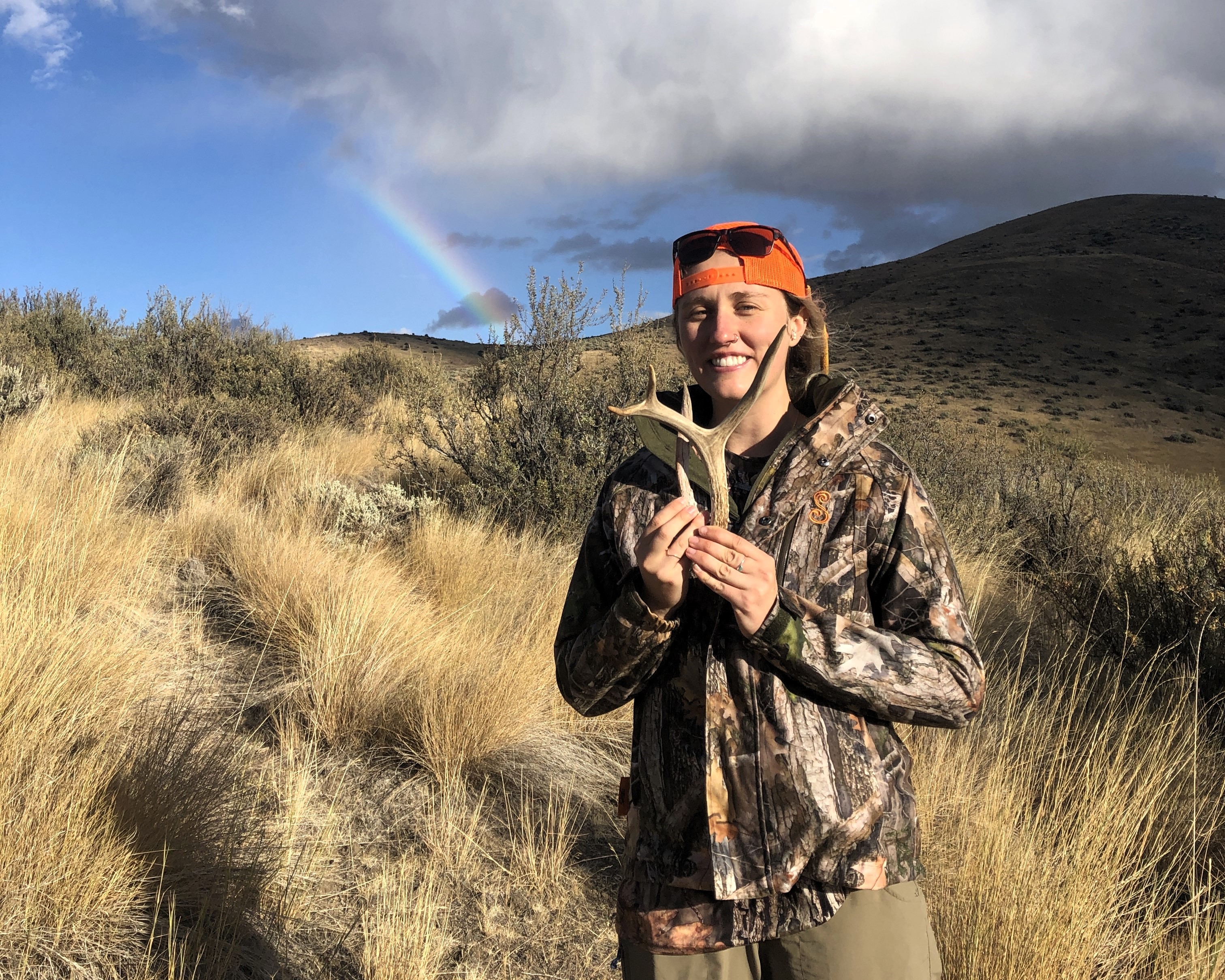 young woman holding a couple of antlers