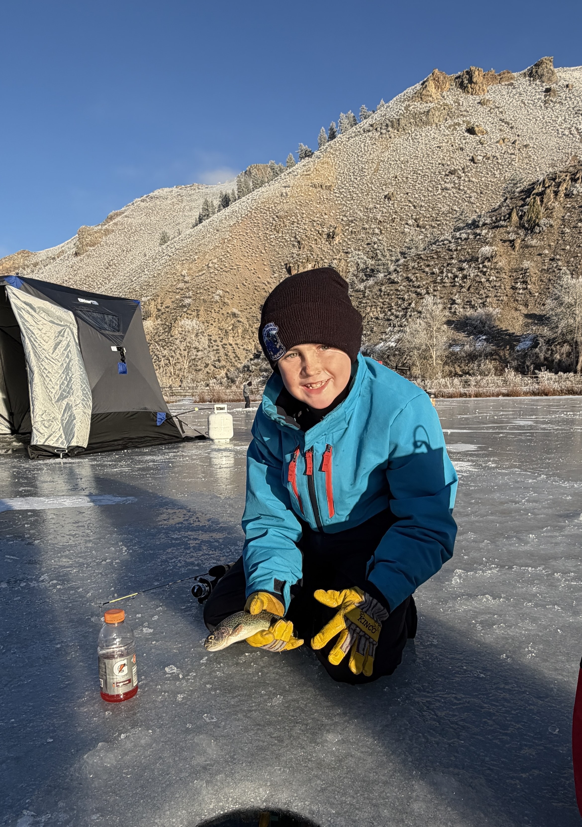 Happy young ice fisherman