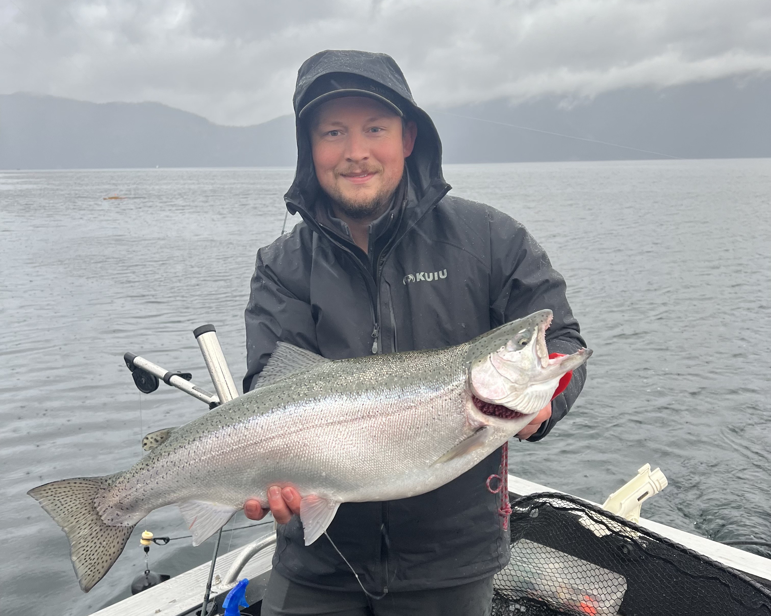 Angler on Lake Pend Oreille with a rainbow trout