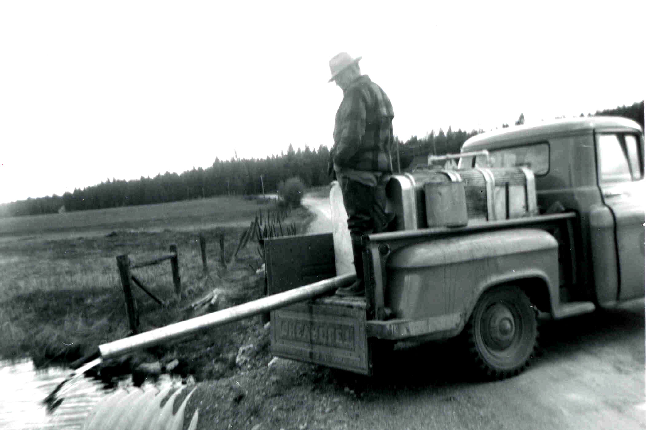 First Mackay Hatchery Manager John Coleman stocking fish from a tank in the back of a 57 Chevy Truck.