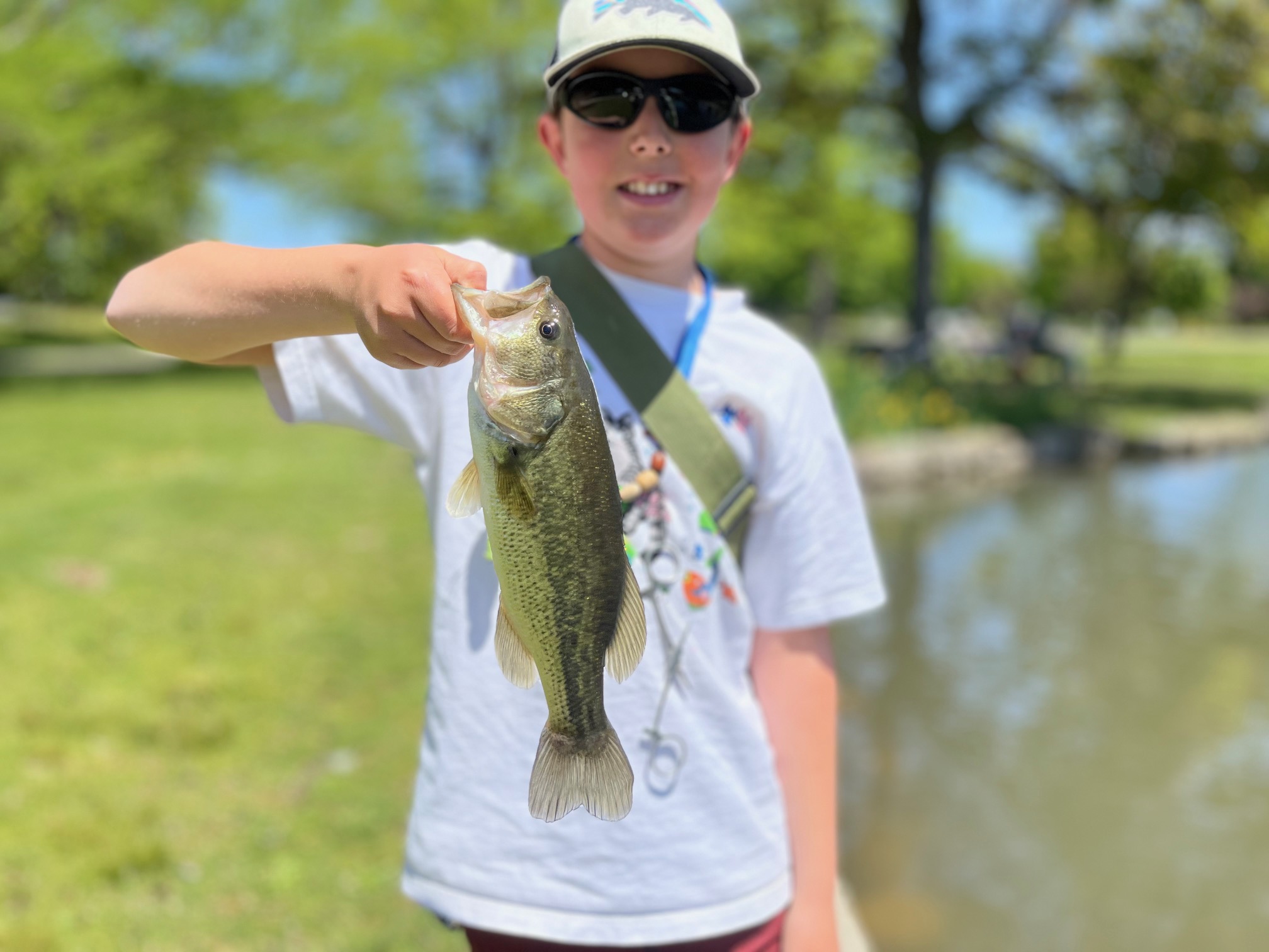 Miles Koenig with a largemouth bass taken from a pond. 
