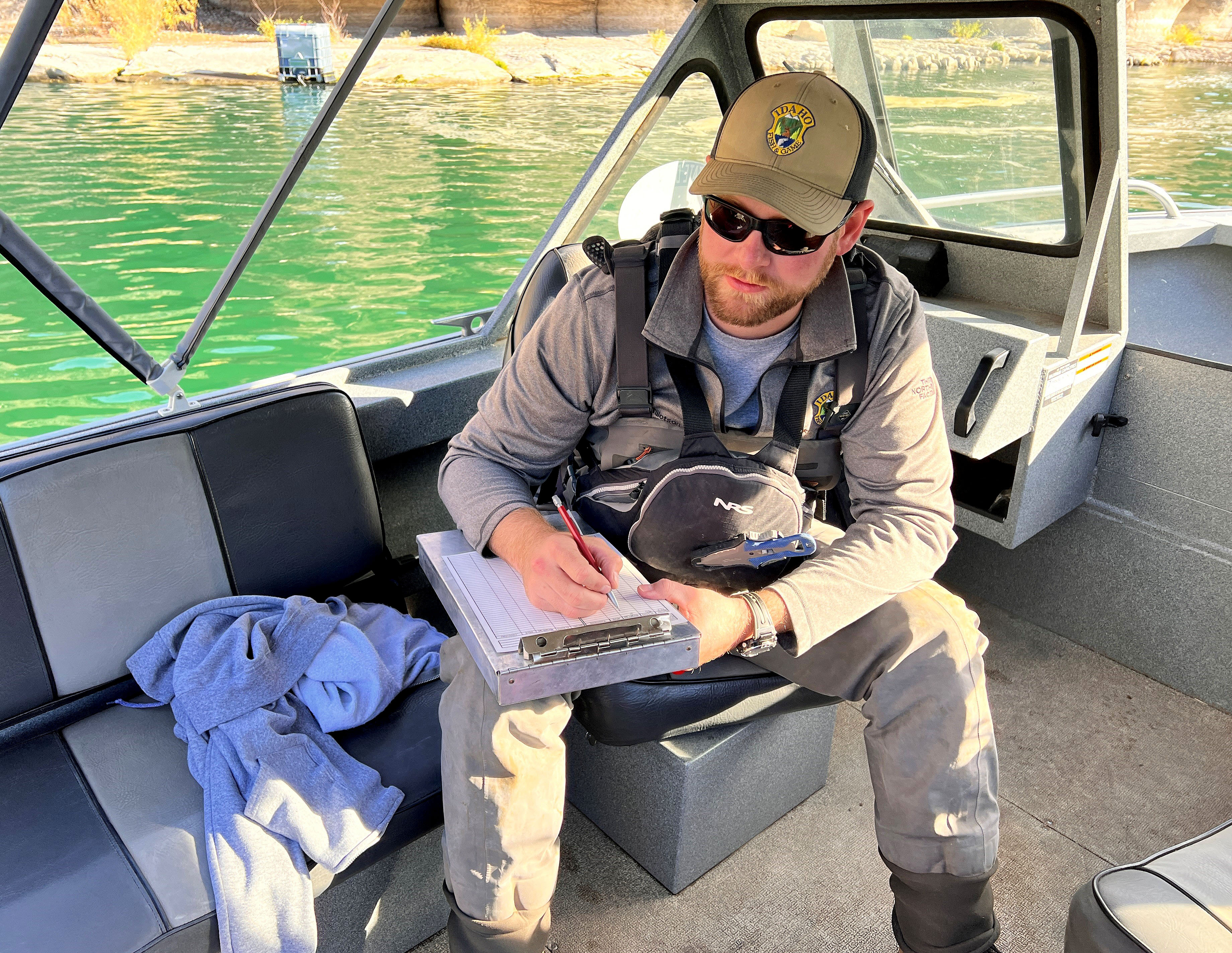 Regional Fisheries Biologist Nate Tillotson records fish mortality data.