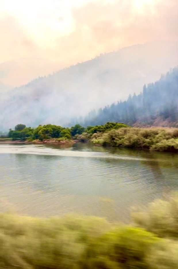 River with wildfire smoke in background