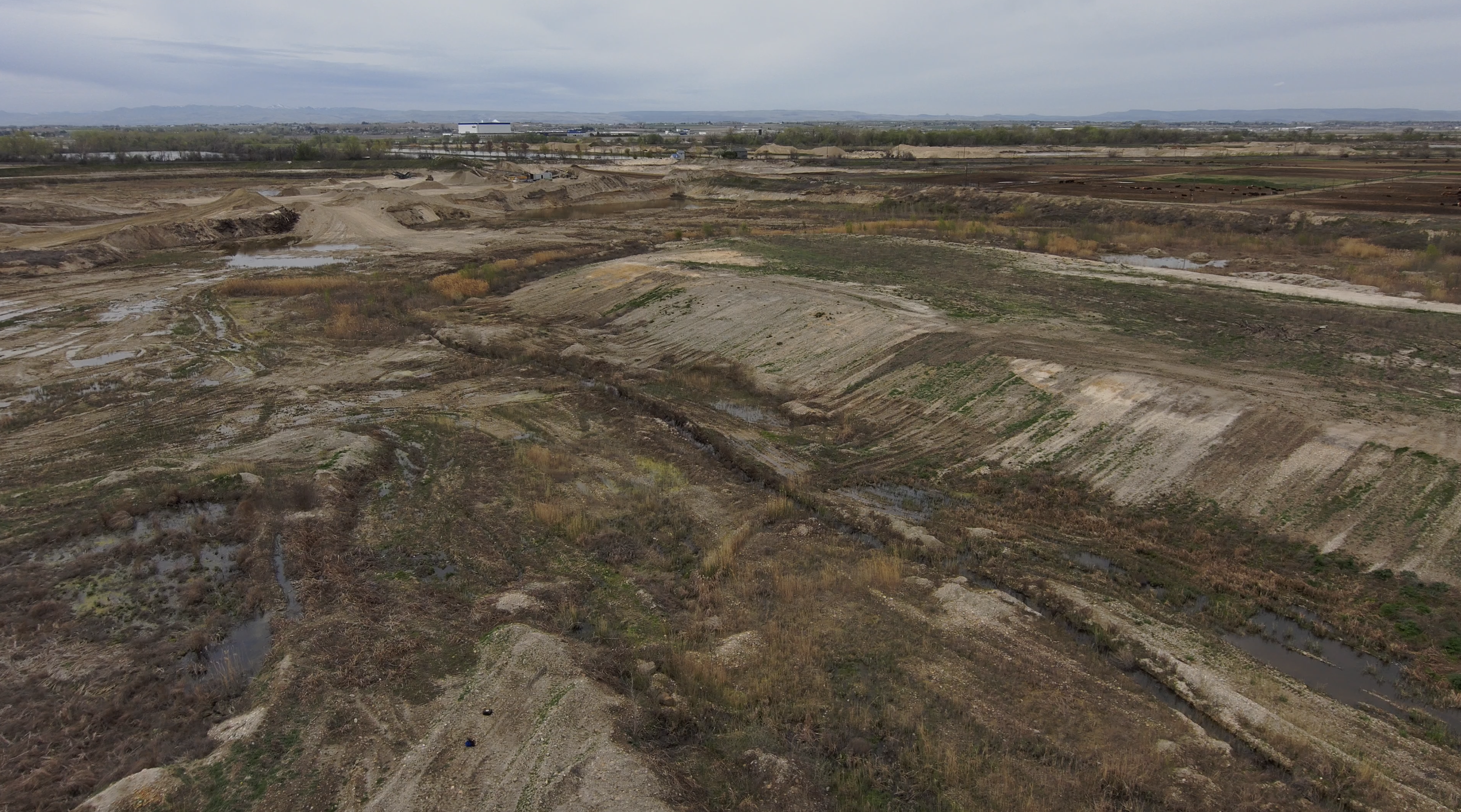 An aerial view of the dray Caldwell Gravel Pond amid ongoing improvement efforts