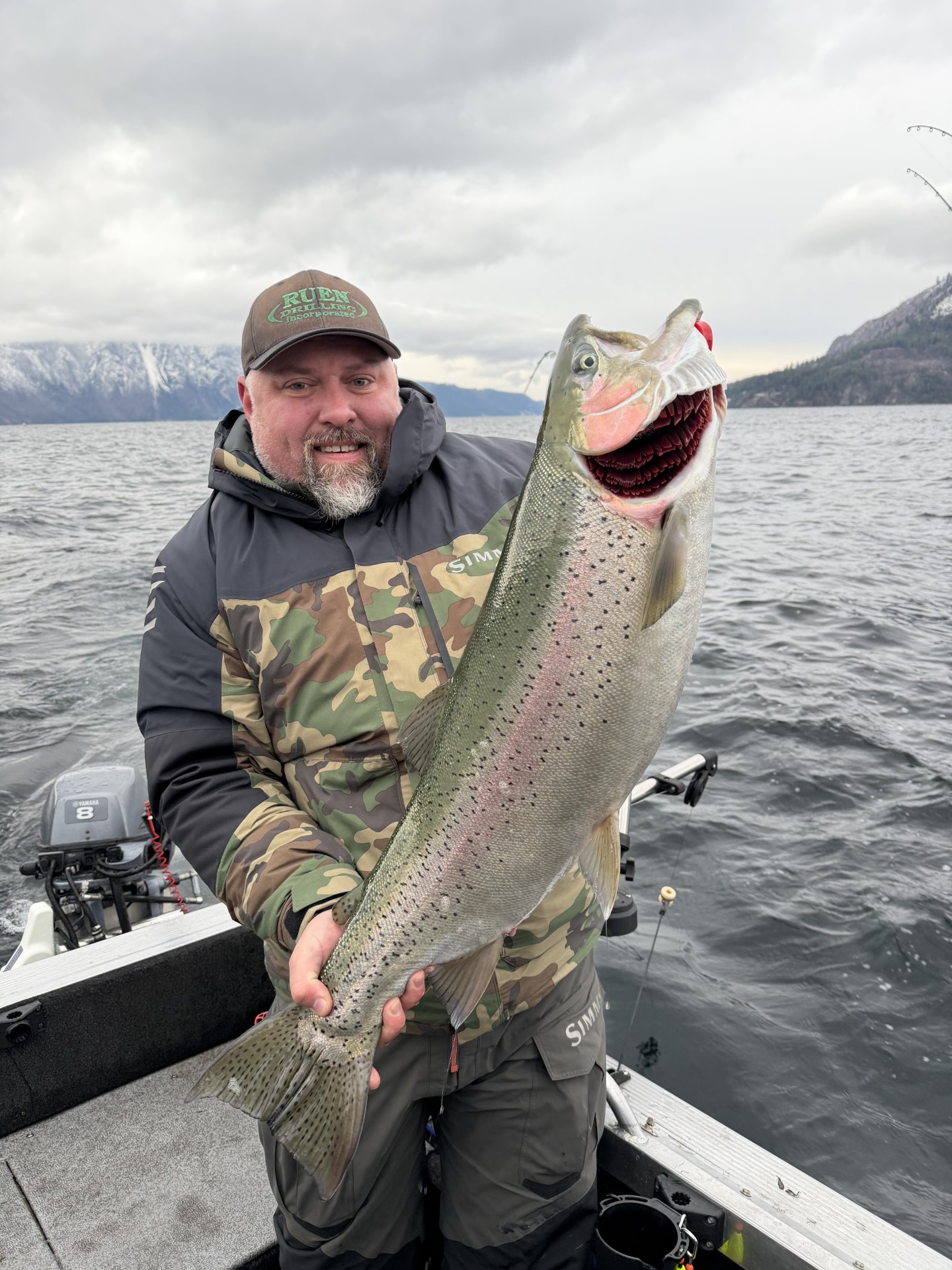 Angler on Lake Pend Oreille with a rainbow trout