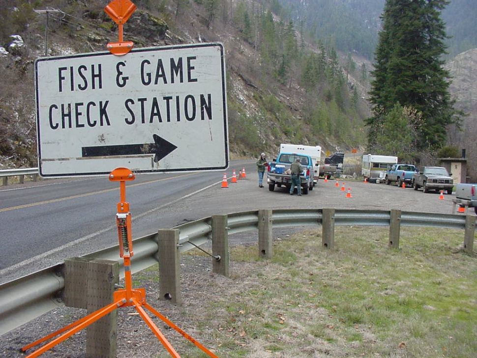 shot of check station sign with activity at a check station October 2000