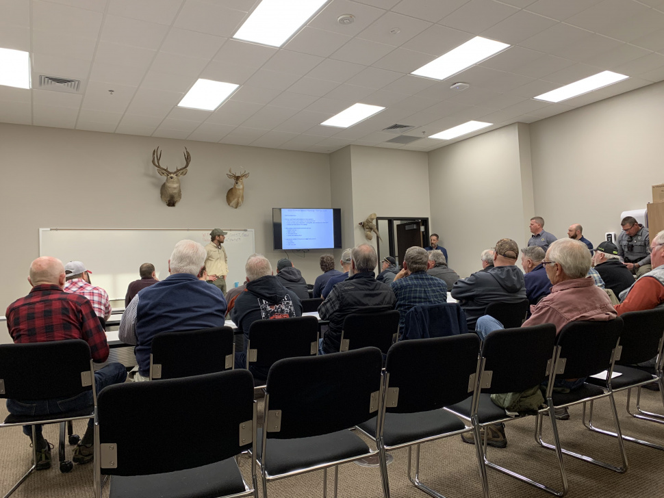 A large group listens at a Chinook public meeting