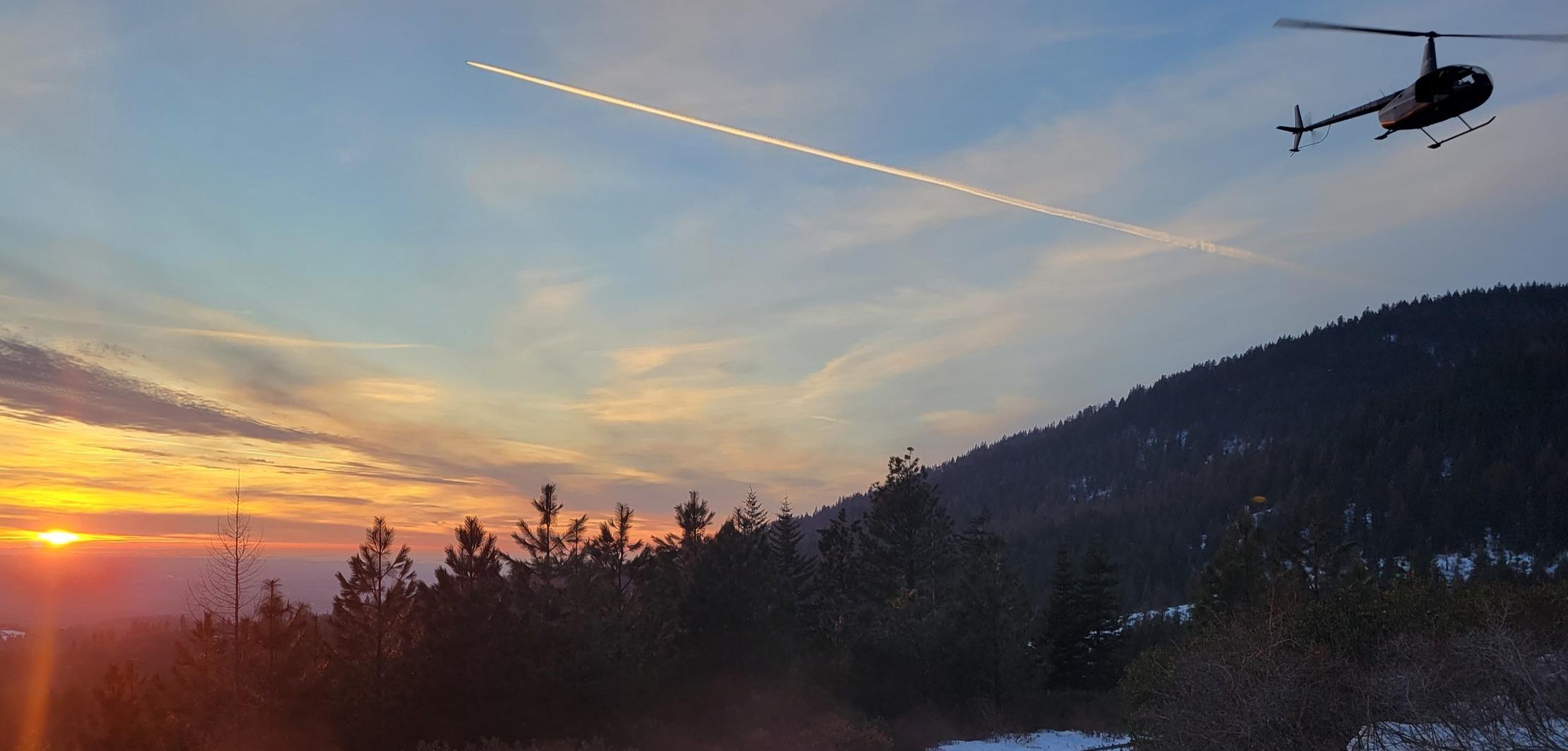 Helicopter in flight for elk captures in North Idaho.