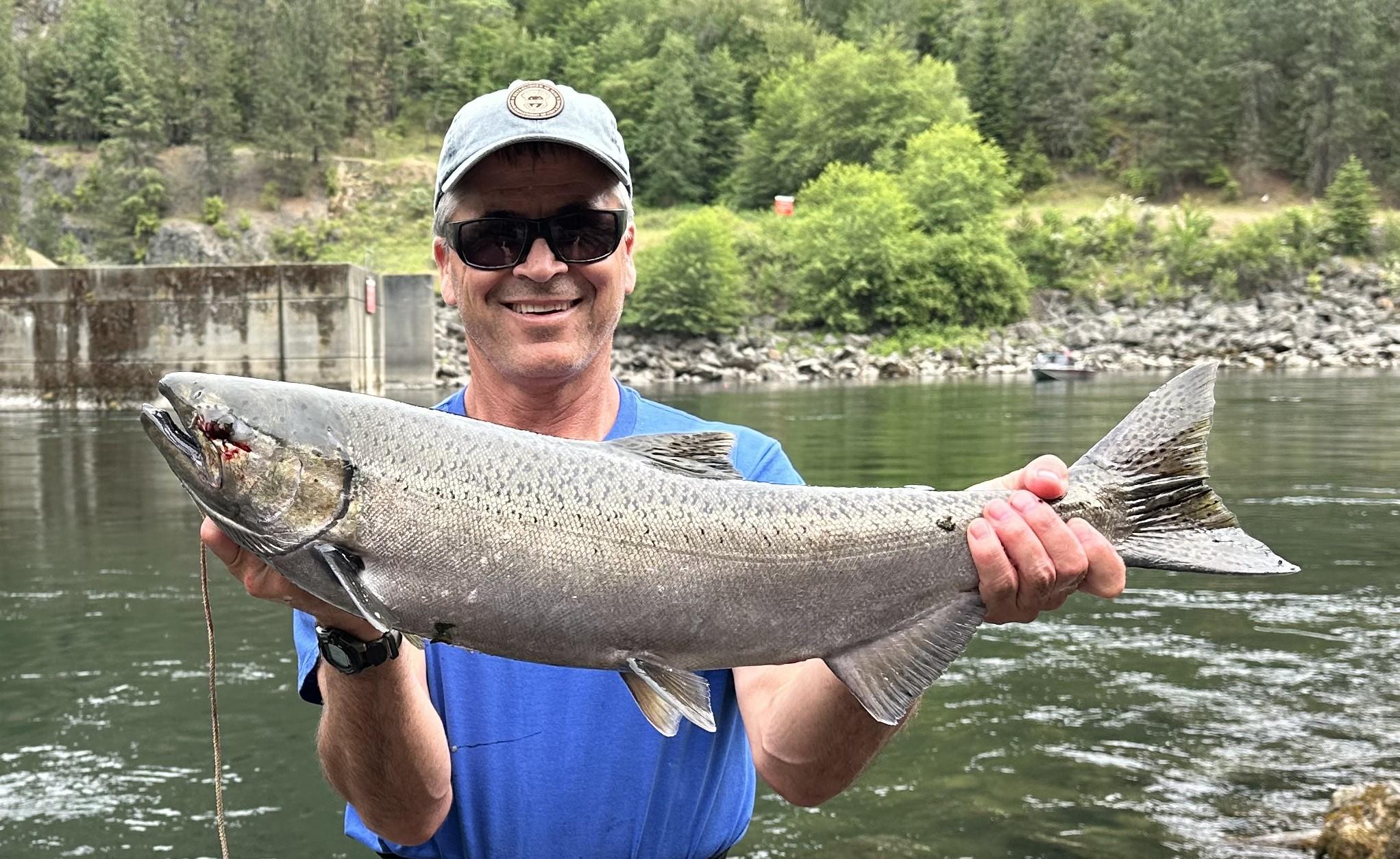 Angler holding a spring Chinook caught in North Fork