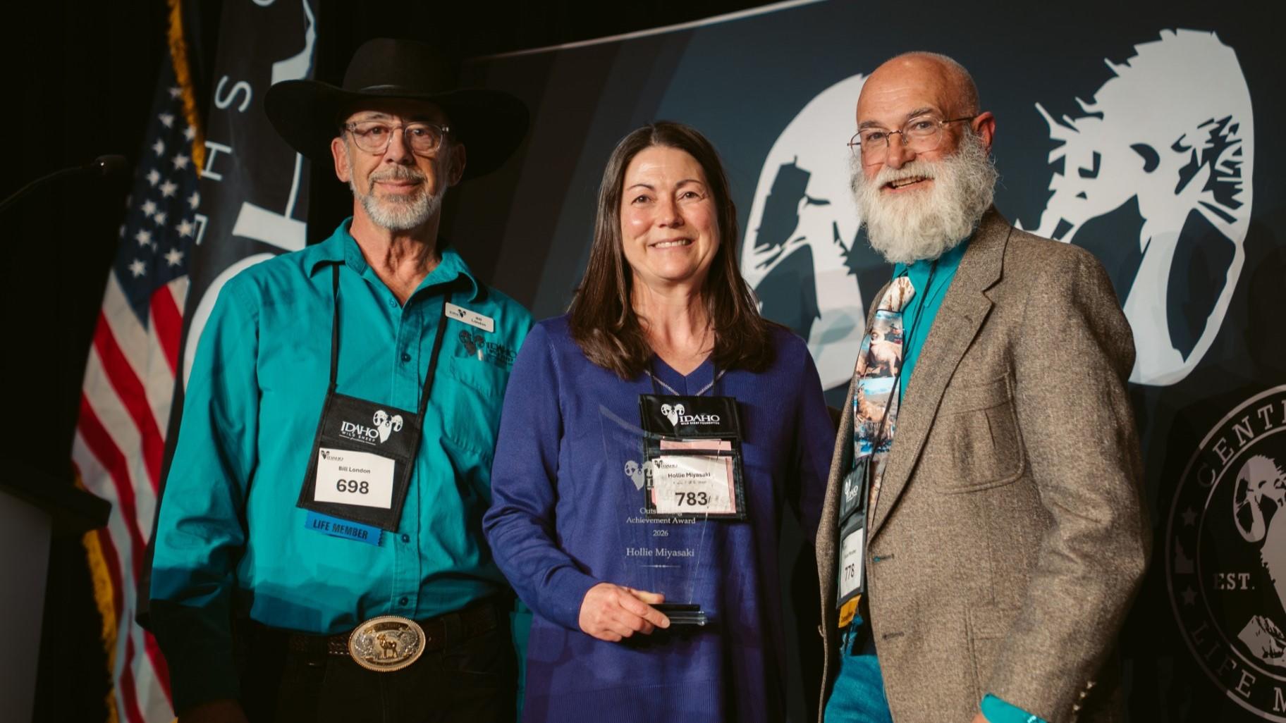 Hollie Miyasaki , Bill London, and Bruce Mincher on stage posing with Conservation Award