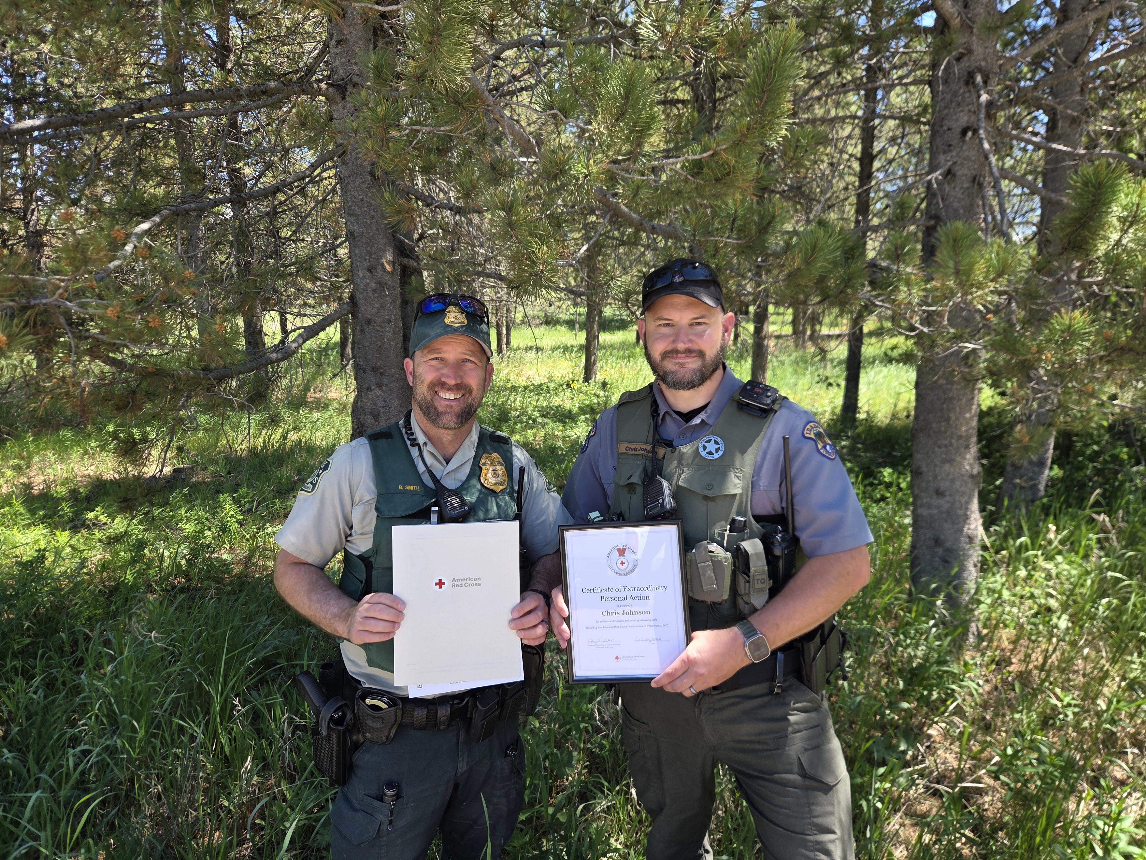 Officers Smith and Johnson holding their American Red Cross Life Saving Awards