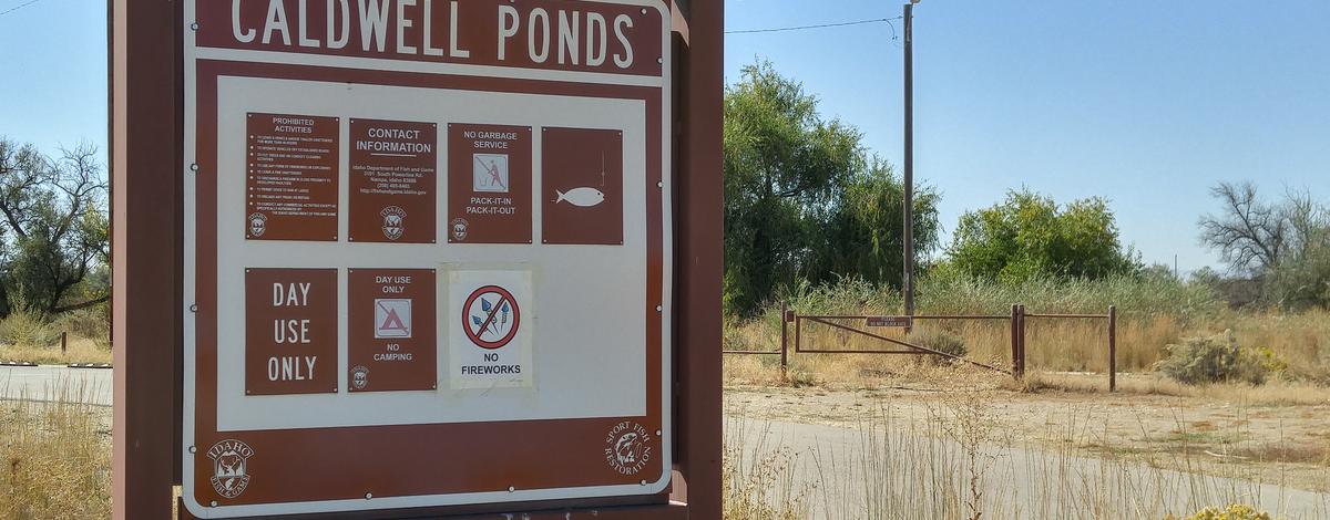 Caldwell Ponds Fishing Access informational sign and road medium shot September 2016