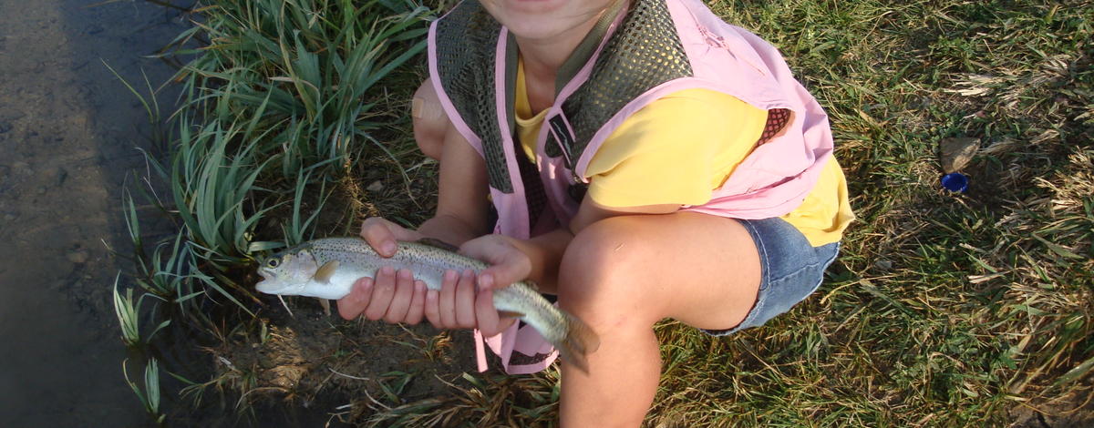 child with rainbow trout