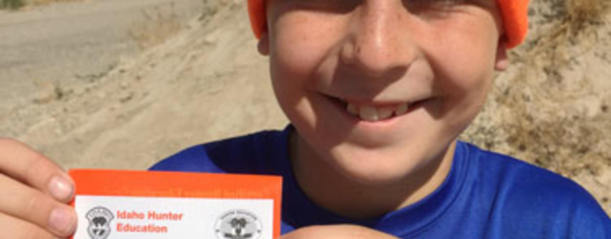 boy with his hunter education card wearing a hunter orange beanie February 2006
