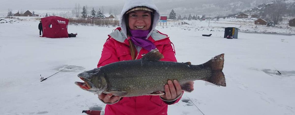 Henry's Lake Ice fishing hybrid cutthroat rainbow trout with happy kid