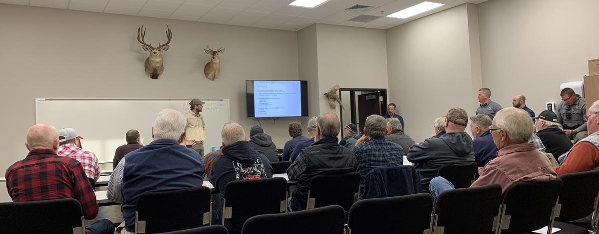 A large group listens at a Chinook public meeting