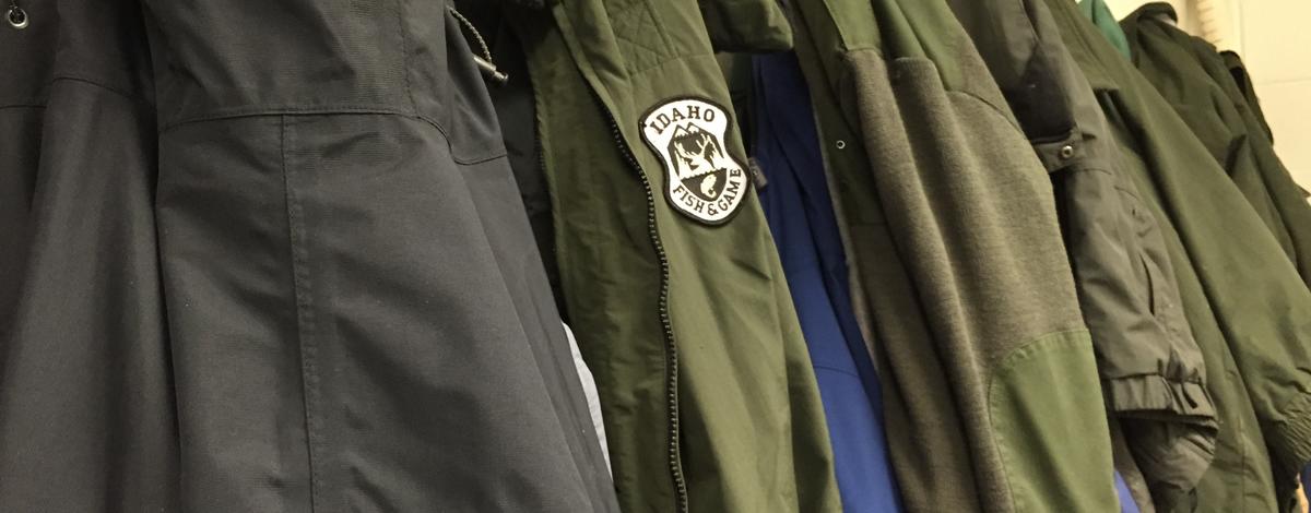Niagara Springs Fish Hatchery jackets hanging on a coat rack one with Fish and Game logo June 2015
