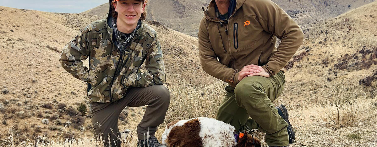 upland bird hunter and son with chukars and bird dog