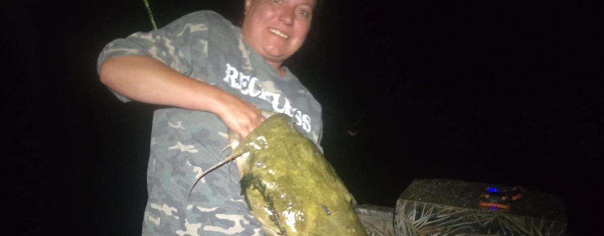 Brandi Holt holding 44-inch flathead catfish from Snake River (horizontal)