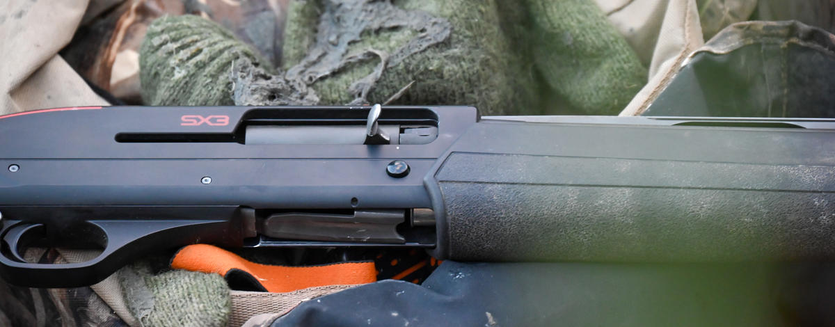 waterfowl hunting shotgun in boat