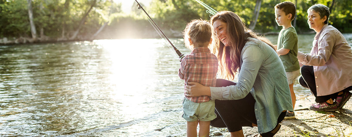 A family fishing near a river