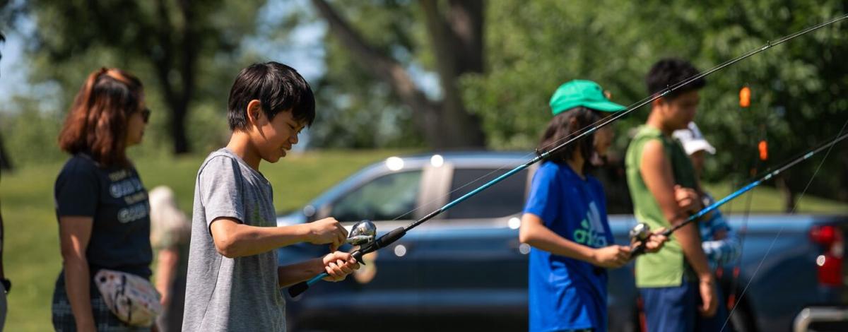 Youth learning how to cast at a Take Me Fishing trailer event