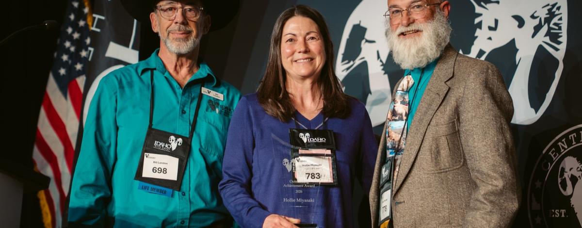 Hollie Miyasaki , Bill London, and Bruce Mincher on stage posing with Conservation Award