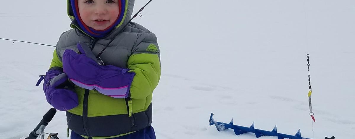 A boy and his firsh fish on the ice