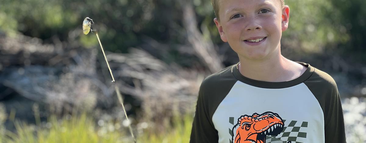 Smiling kid holding a fishing pole