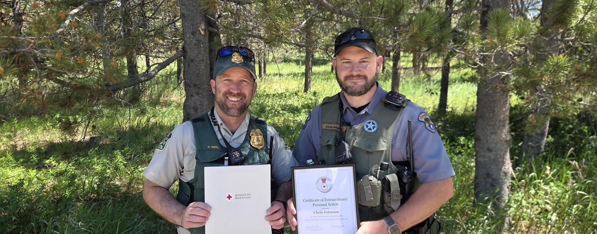 Officers Smith and Johnson holding their American Red Cross Life Saving Awards
