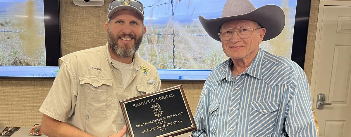 Sammie Hendricks being presented the 2023 Hunter Education Instructor of the Year award by Gerren Steel