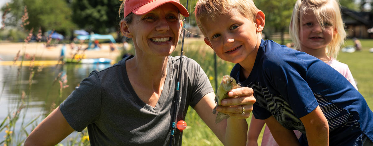 woman and boy holding a fish