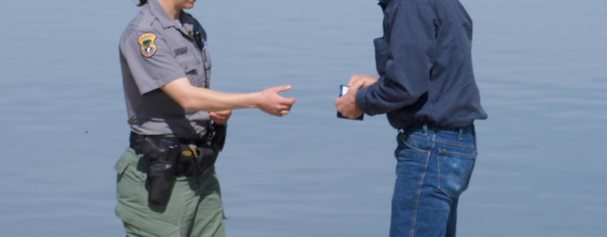 Idaho Fish and Game conservation officer Meghan Roos checks a fishing license near Castleford  March 2010