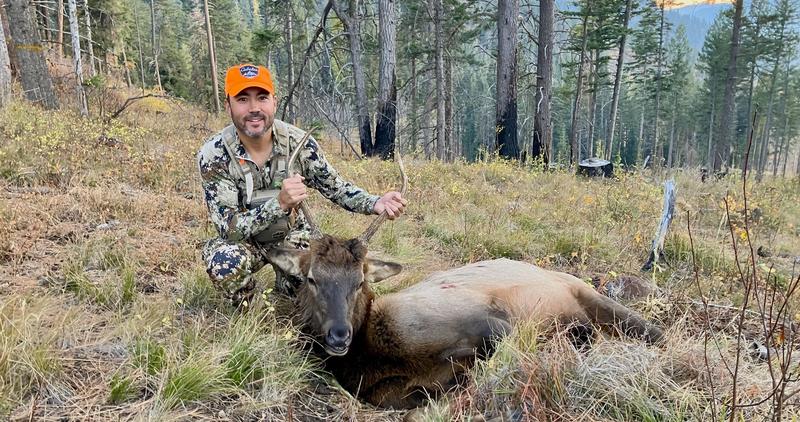 hunter posing with spike bull shot in 2025