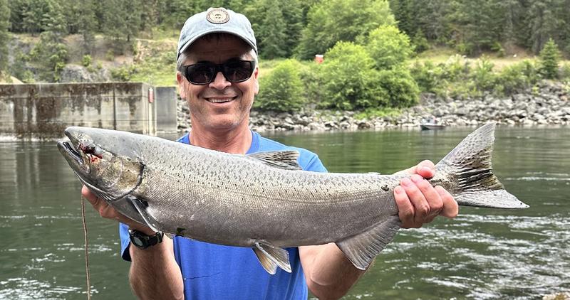 Angler holding a spring Chinook caught in North Fork