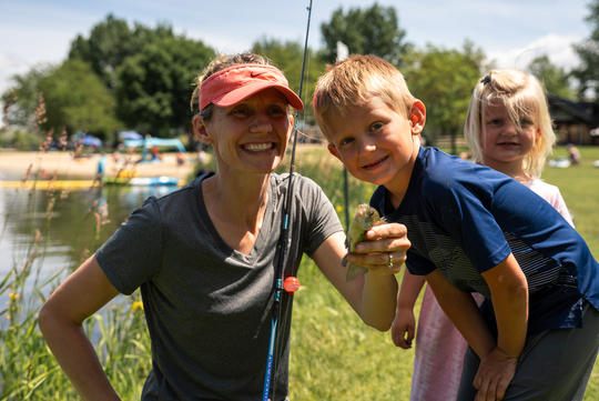 woman and boy holding a fish
