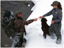 an IDFG  conservation officer checks the tag and license of a hunter 