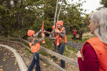 girls learning how to cross a fence with rifles on hunter education field day October 2015 
