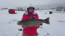 Henry's Lake Ice fishing hybrid cutthroat rainbow trout with happy kid