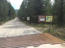 Horsethief  Reservoir Fishing Access cattle guard, informational signs, road medium shot August 2015