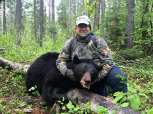 man with his black bear 