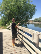 boy fishing from a bridge at Hagerman ponds medium shot June 2015